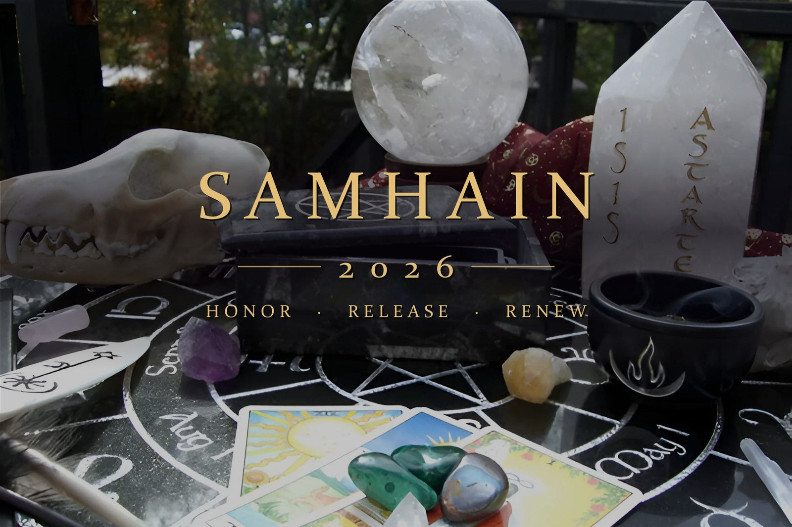 Samhain altar with a clear quartz sphere, engraved Isis and Astarte quartz point, pentacle box, tarot cards and an animal skull on a Wheel of the Year board