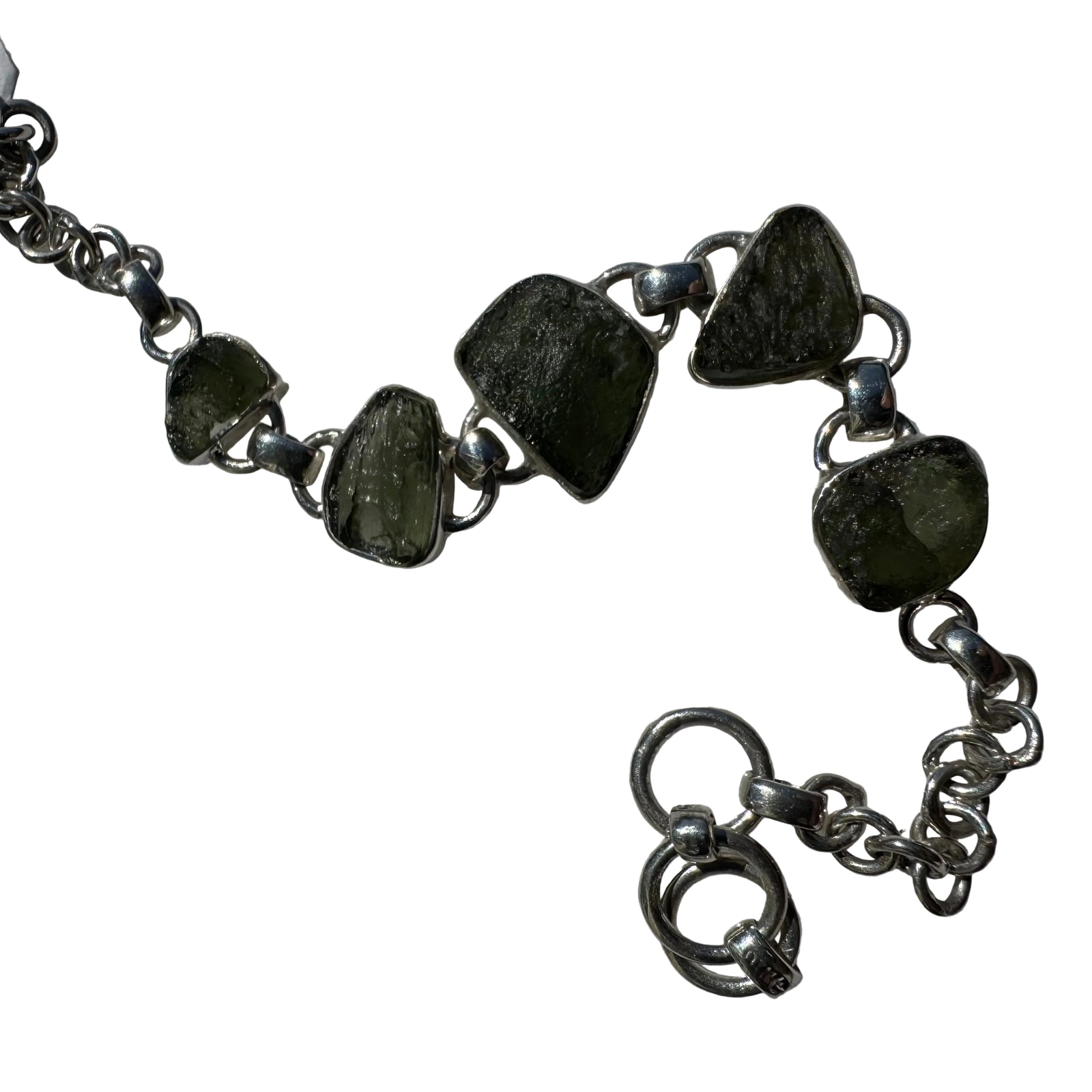 Silver bracelet with green stones on a light white background