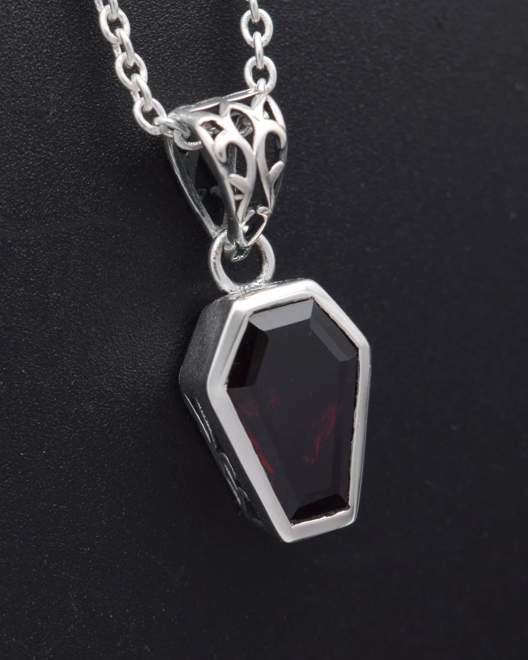 Close-up of the coffin-cut garnet pendant on its adjustable silver chain