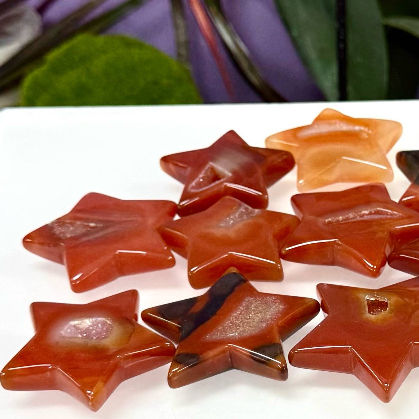 Star-shaped stones on a white surface with a brand label in the corner.