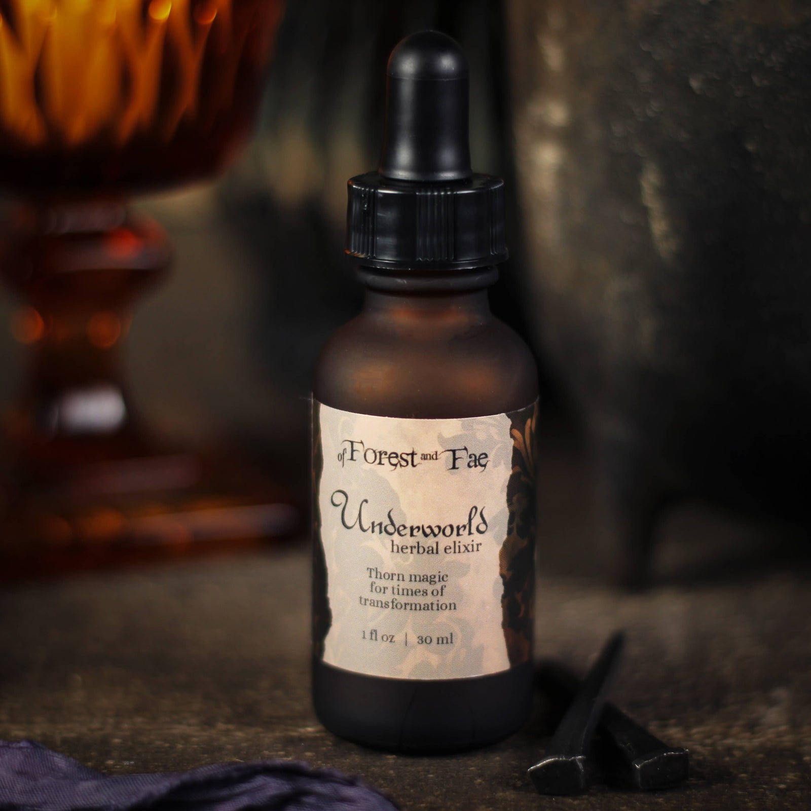 Underworld herbal elixir bottle labeled Thorn magic for times of transformation, close-up