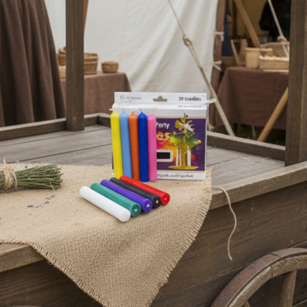 Set of colorful candles in front of a box labeled '20 Candles' with a party theme.