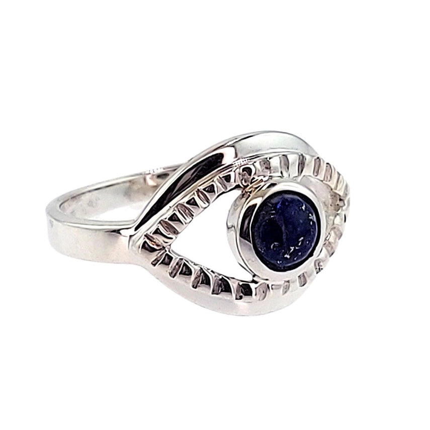 Silver ring with a pear-shaped diamond on a white background
