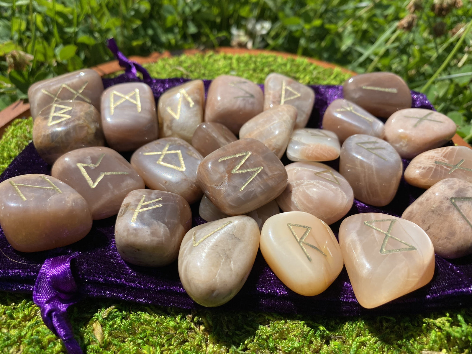 Moonstone rune sets of 25 engraved stones. Variety of styles, Futhark, Angel, Reiki symbols, Astrology, Theban, witch's Runes and more. Custom orders welcome