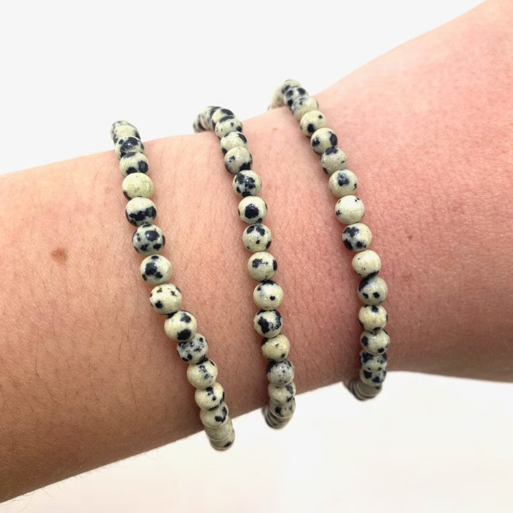 Add some natural beauty to your wardrobe with the Dalmatian Jasper Stretch Bracelet. Made from smooth and polished beads of Dalmatian Jasper, this bracelet has a sleek and stylish look and is believed to promote feelings of calm, well-being, loyalty, friendship, and happiness.