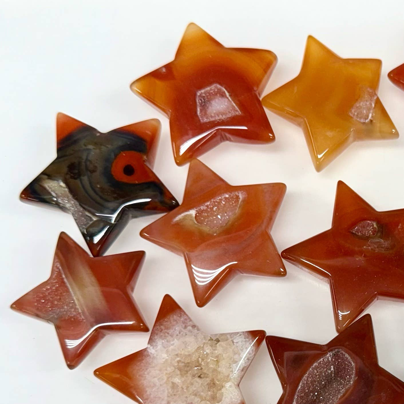 Star-shaped stones in various colors on a white background.