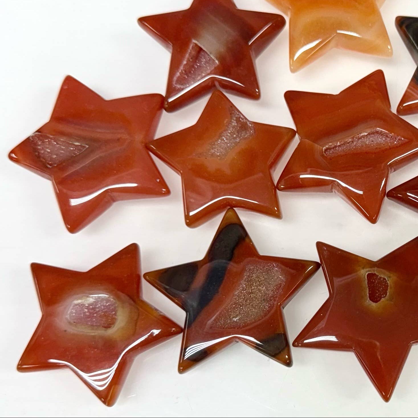 Star-shaped stones in various colors on a white background