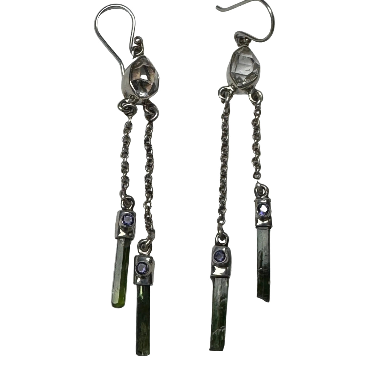 Pair of silver earrings with gemstone drops on a white background