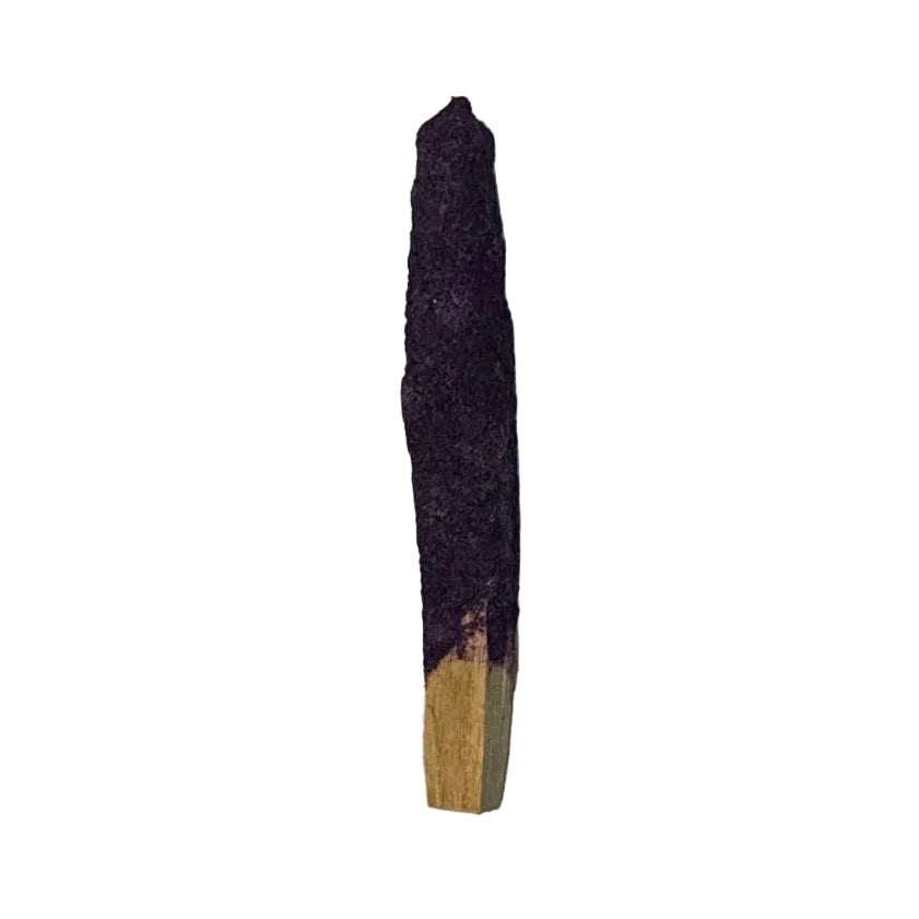 Incense stick with a purple top and wooden base on a light wooden surface