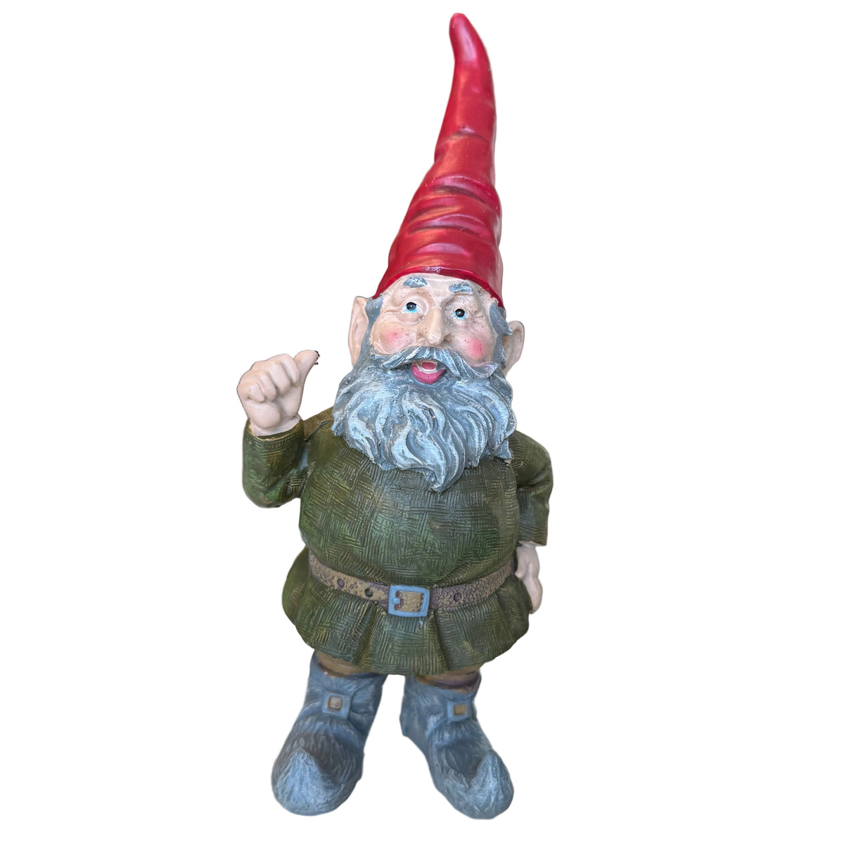 A garden gnome figurine with a red pointed hat, gray beard, green outfit, and gray boots, standing on a glass display counter in a shop. A black decorative orb sits to the right.