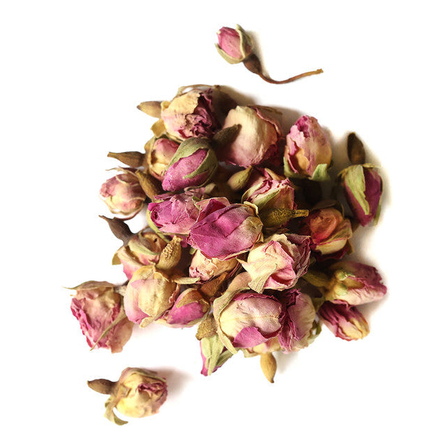 Dried pink rose buds on a white background