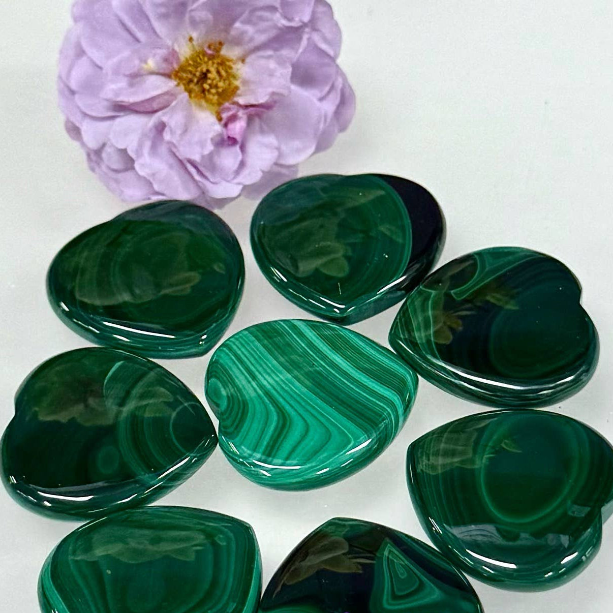 small malachite hearts near a purple flower