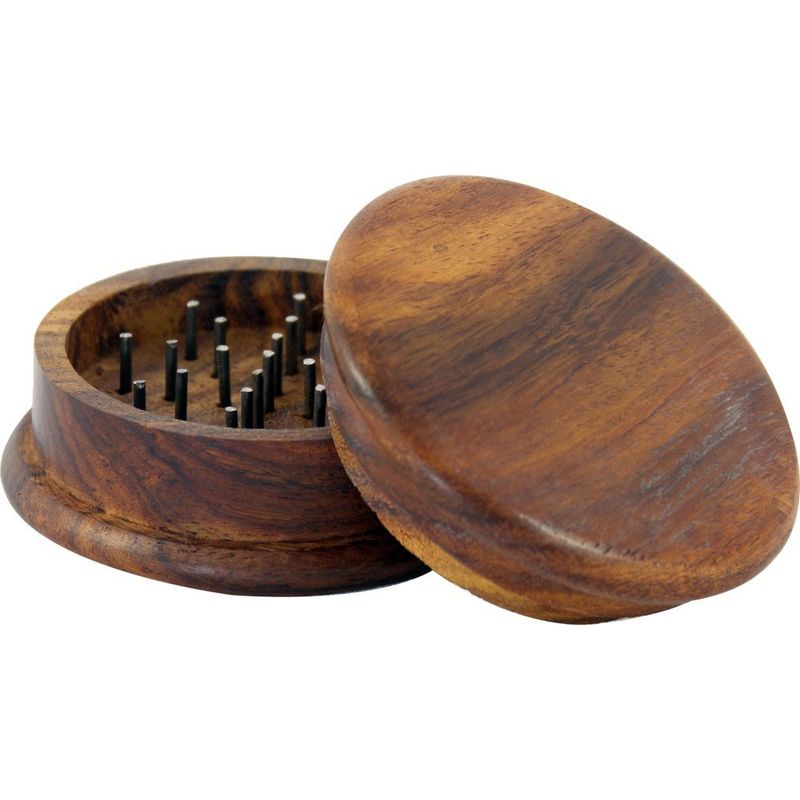 Wooden grinder with metal components on a white background