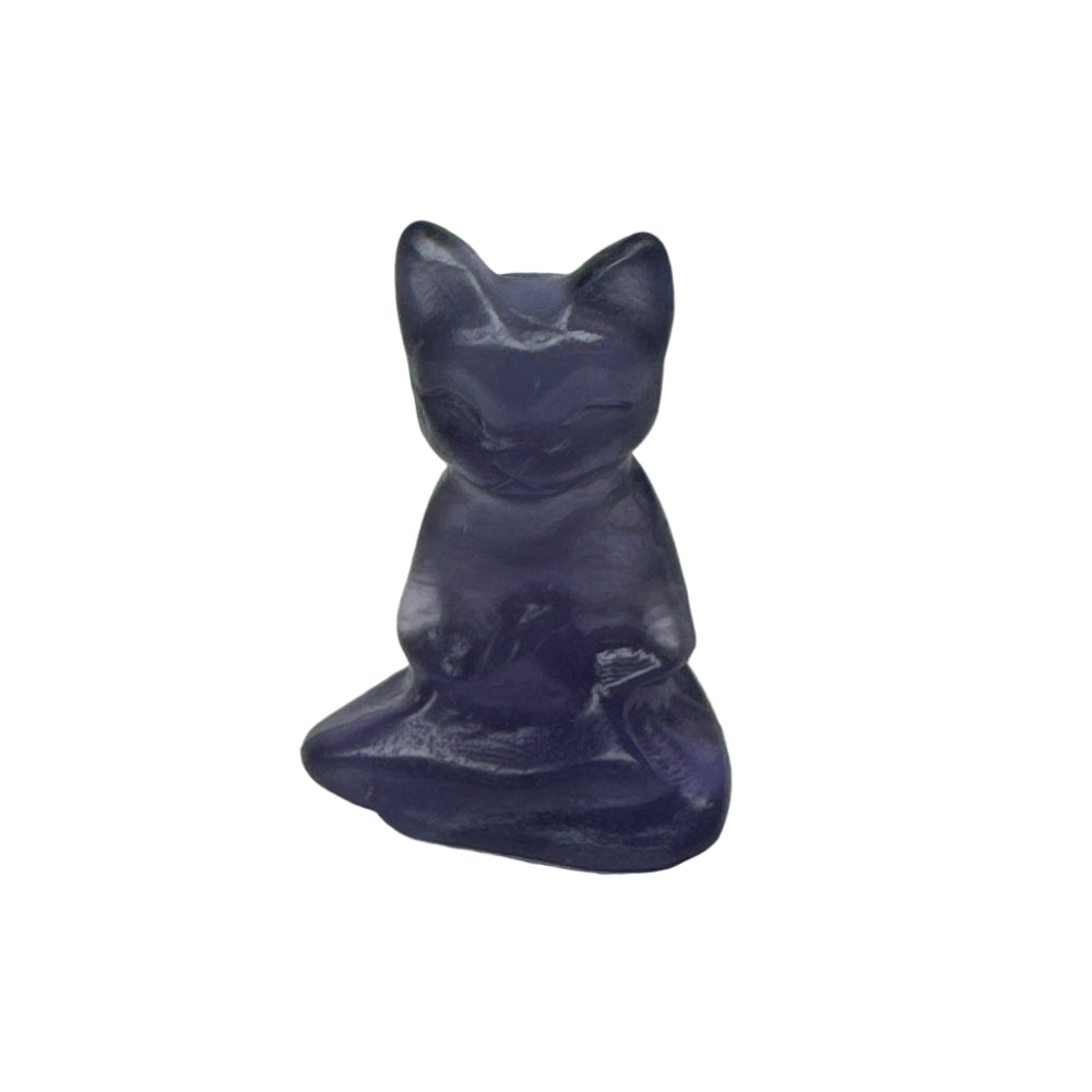 Purple stone object shaped like a cat on a white background