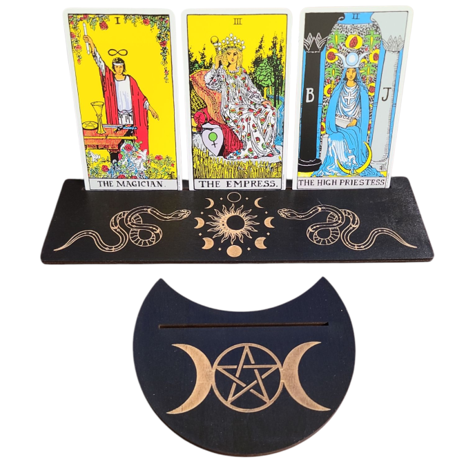 Three tarot cards displayed on a stand with a pentacle symbol below.