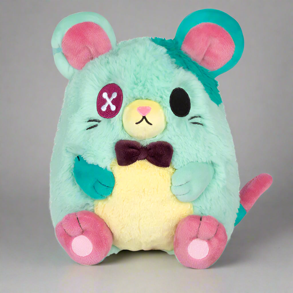 Plush toy resembling a stylized mouse with teal fur, pink ears, and a yellow belly.