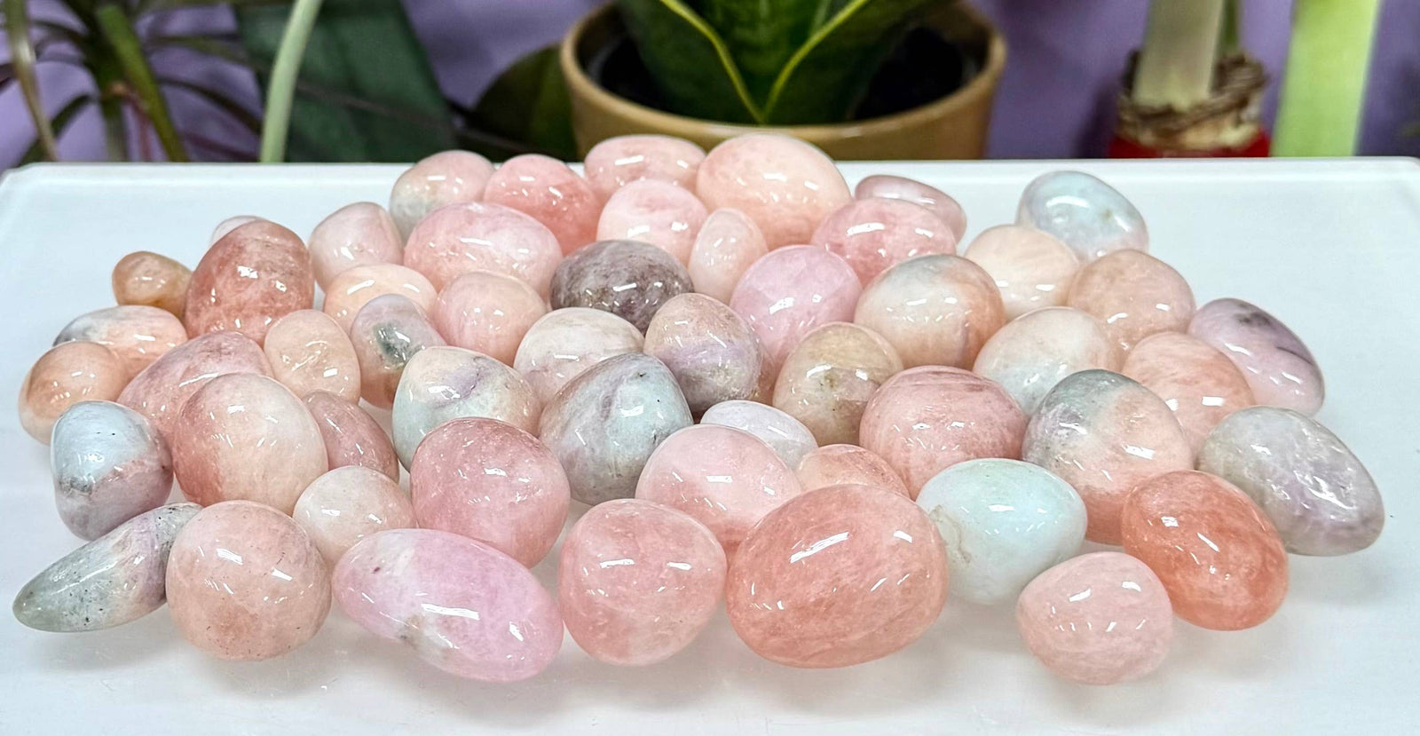 Multicolored gemstones on a white surface with a blurred background