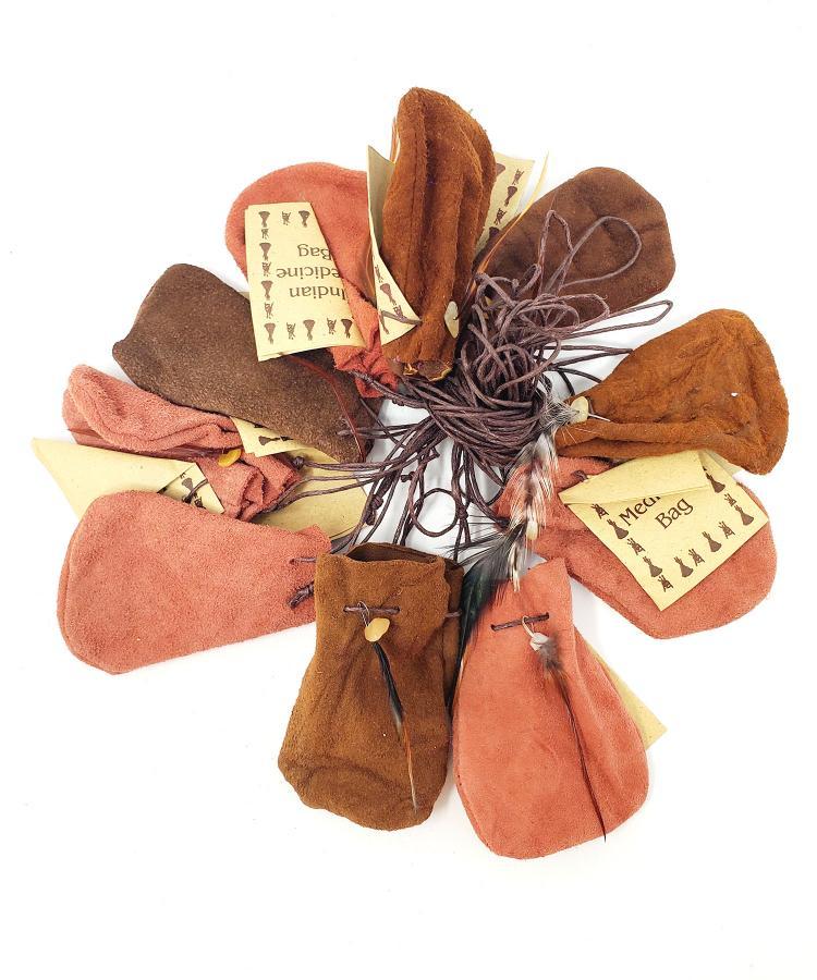 Set of brown and orange fabric bags with decorative elements on a white background