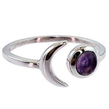 Silver ring with a purple gemstone on a white background