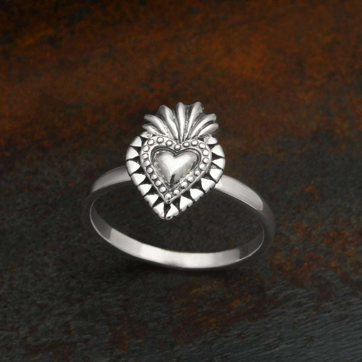 This sterling silver flaming heart ring is both fierce and romantic. Within the Catholic faith, the sacred heart is a medieval symbol of Christ&#39;s sacrifice. The sacred heart signifies the redeeming love of God as the source of illumination and happiness.