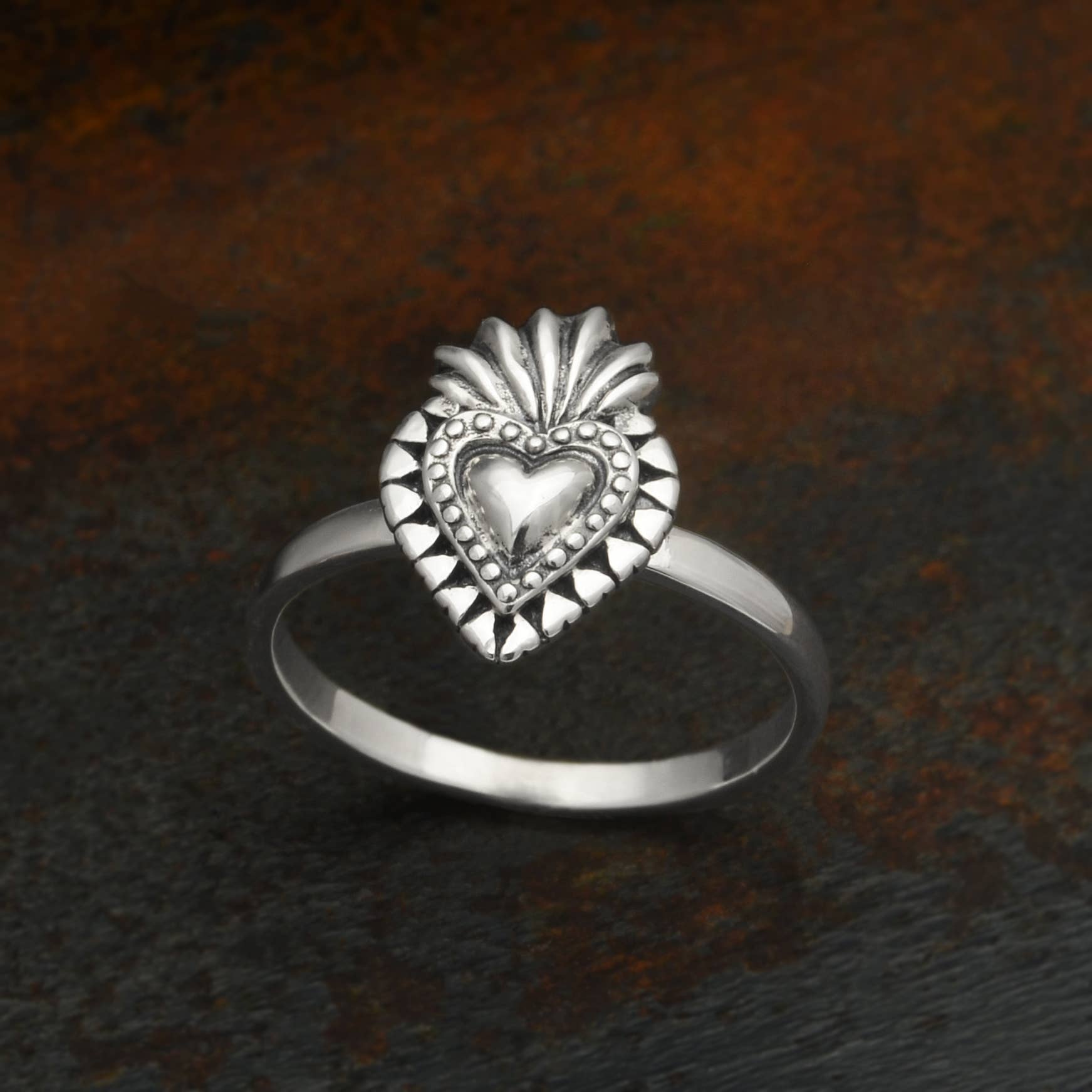 This sterling silver flaming heart ring is both fierce and romantic. Within the Catholic faith, the sacred heart is a medieval symbol of Christ's sacrifice. The sacred heart signifies the redeeming love of God as the source of illumination and happiness.