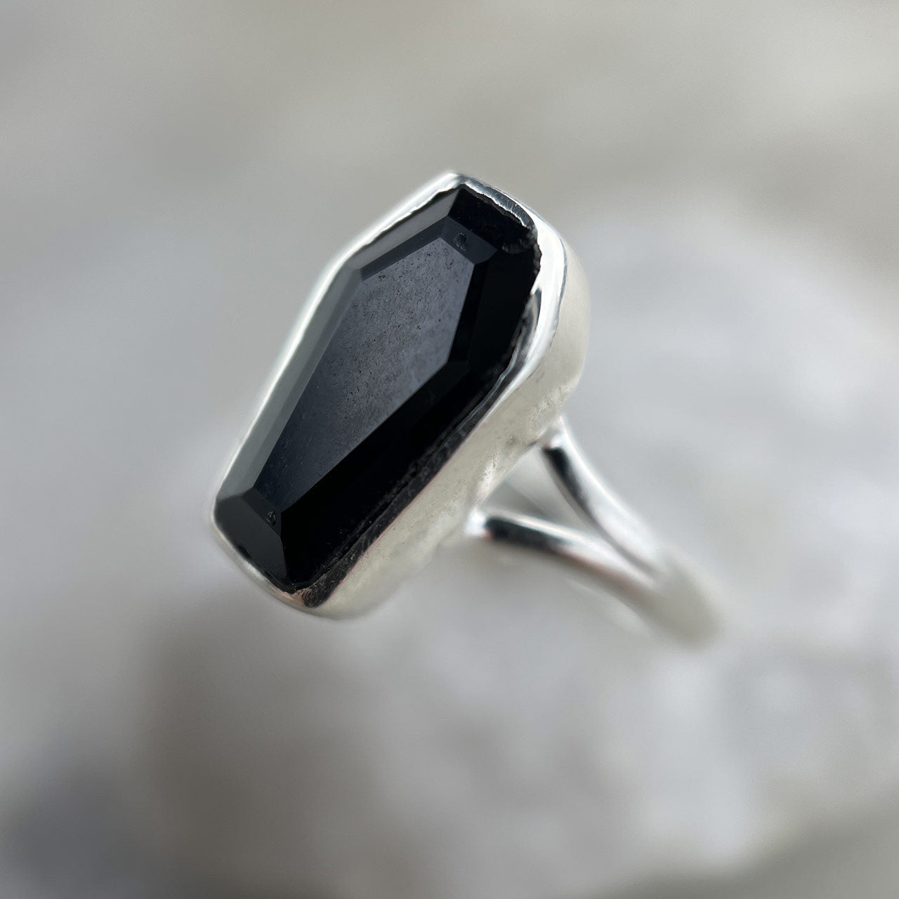 Made of the finest sterling silver and Black Onyx, these coffin rings will bring delight into the lives of any enthusiasts of the spooky, scary, and macabre. The brilliance of the gems ties in perfectly with the fine bone-shaped banding, reminding us of Memento Mori. Life may be fleeting but should be lived with vibrancy and passion. Wear this ring and remember to live as brightly as the jewel’s shine.
