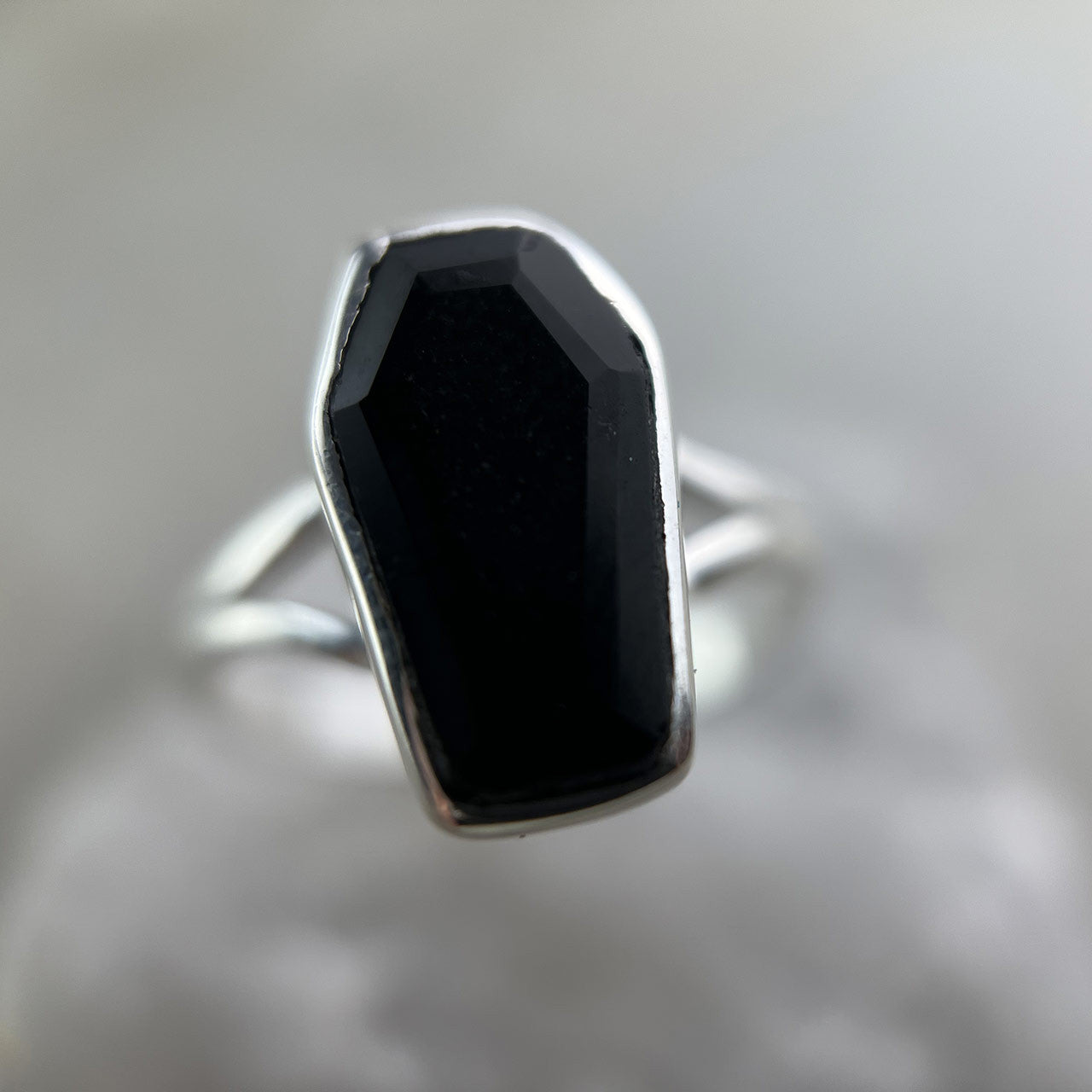 Made of the finest sterling silver and Black Onyx, these coffin rings will bring delight into the lives of any enthusiasts of the spooky, scary, and macabre. The brilliance of the gems ties in perfectly with the fine bone-shaped banding, reminding us of Memento Mori. Life may be fleeting but should be lived with vibrancy and passion. Wear this ring and remember to live as brightly as the jewel’s shine.