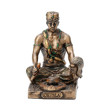 A bronze-colored cold cast resin statue of the Orisha Orunla, seated and holding a rattle with a snake around his neck, on a square base.