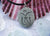 Tibetan Om symbol - engraved Beach Stone Pendant - Seed of Creation necklace - Cast a Stone