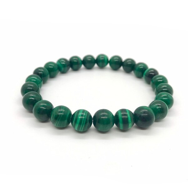 "Real Congo Malachite Stretch Bracelet - 7-8mm" - A close-up image of a wrist with the Real Congo Malachite Stretch Bracelet on it. The bracelet features genuine malachite beads in varying shades of green, with unique striations and patterns visible on each bead. The stretchy design allows it to fit comfortably on most wrist sizes.
