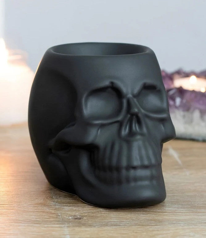 Made from ceramic with a matte black coating this chique skull burner will surely catch some eyes. Be you an avid collector of skulls, budding anatomist, wild witch, or king of the dead, simply place a tealight in this captivating cranium along with some of your favorite scents and enjoy the gentle flickering of candlelight and its drop-dead gorgeous scents from dusk till dawn.